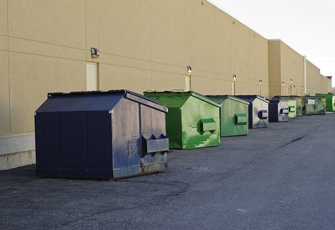 construction workers disposing of debris in large dumpsters in Brooklyn IN